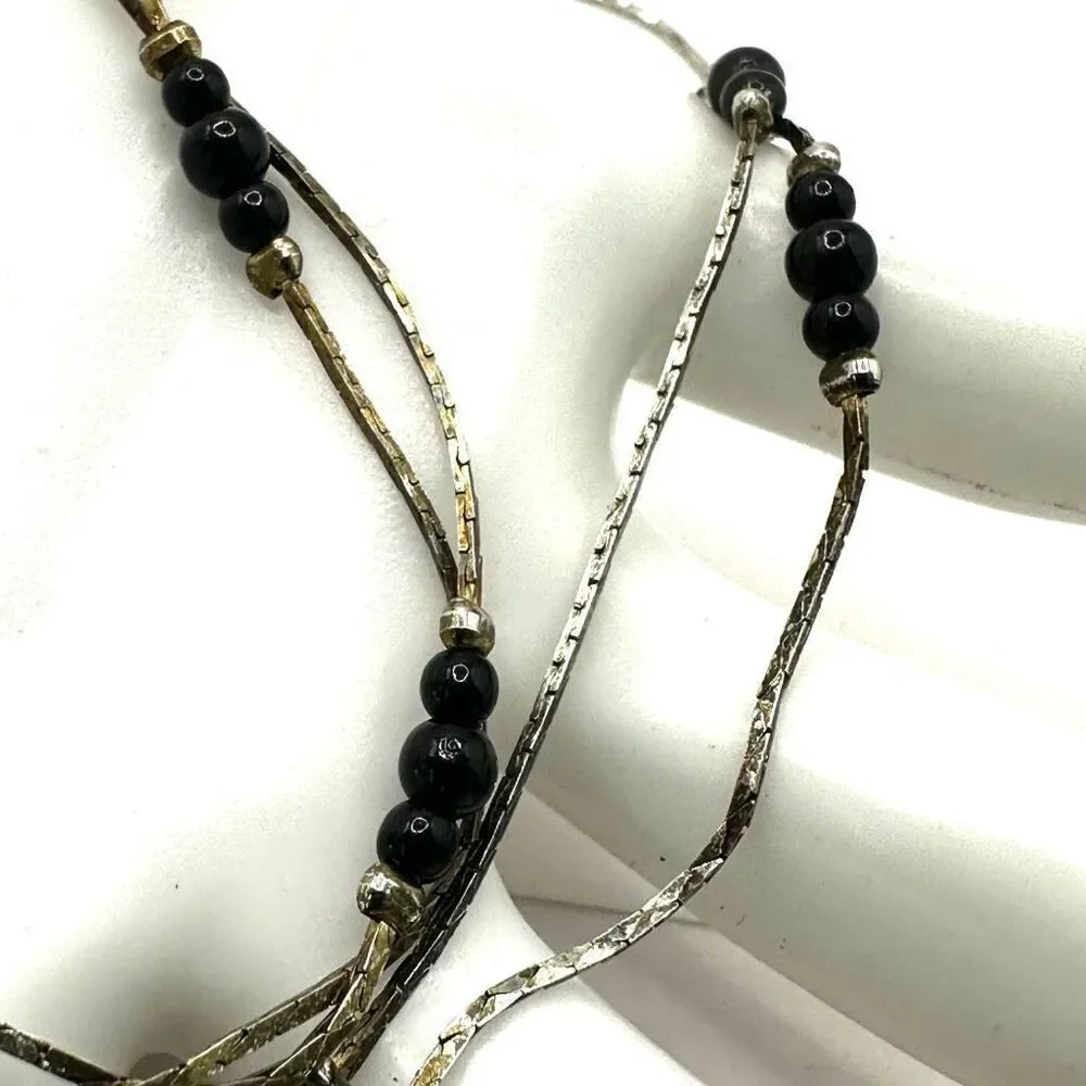 Black and silver tone long beaded necklace